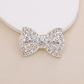 Macro shot of silver bow decoration with white pearls and sparkling rhinestones - D1984 White Rhinestone Bow (Silver Base)