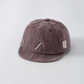 Close-up of deep brown corduroy baby baseball cap with soft brim and fine embroidery - 44-50cm (1-2 Years) / Burgundy