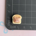 Macro shot of 1.5cm resin toast bear accessory for DIY crafts and jewelry making - Brown Bear Toast Slice
