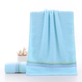Light blue cotton towel with purple and green stripe accents in folded and hanging view - Weak Twist Colorful Stripe Blue / 34*74cm