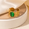 Detail of a vintage gold adjustable ring with green cat eye stone and hollow carving - Scroll Pattern Green Stone Adjustable Style (TYR0817)