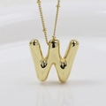 Detailed view of a golden bubble-style letter W pendant with a polished finish and thin chain - Letter W (Necklace)
