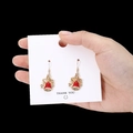 Festive Christmas bell earrings with red bow and golden finish on card holder - Red Bell