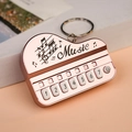 Mini piano music keychain in rose gold finish with numbered keys and music motif - Bag Packaging / Rose Gold