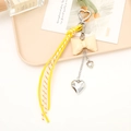 Detail of yellow woven cord and beige leather bow keychain with silver heart pendant - Creamy White Bow