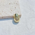 Gold plated oval bead charm with butterfly crystal pavé on beige stone background - Butterfly Zirconia Style / Gold