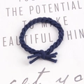 Detail of hand-woven dark blue braided elastic hair tie with knotted texture design - Navy Blue