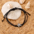 Detail of adjustable black cord anklet with silver turtle pendant on beach corals - Antique Silver Black Style (K-266)