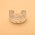 Macro view of silver stainless steel open bangle with unique textured hollow design - Silver Hollow Bark Texture Style (HZ47999AW0)
