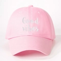 Close-up detail of Good Vibes white embroidery on a light pink cotton baseball cap - Light Pink