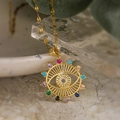 Gold plated evil eye sun pendant necklace with multicolored zircon stones on marble surface - Evil Eye Pendant (24363) / Gold