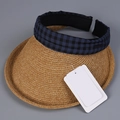 Detail of a straw sun visor featuring a navy plaid fabric headband and hanging tags - M (56-58cm) / Navy Blue