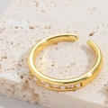 Detail shot of a gold open ring featuring alternating pearls and square zirconias on stone - Square White Zirconia Artificial Pearl Style