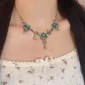 Bohemian vintage necklace with blue crystals and floral tassel on neck model - Bronze Floral Blue Rhinestone Water Drop Tassel Necklace (X5637)