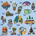 Flat lay of 15 colorful embroidered patches with mountain, camping, and outdoor themes - Style 16/15Pcs Set