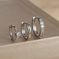 Detailed macro shot of silver S925 earrings set with cubic zirconia and polished finishes - Silver (Y26070)