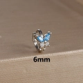 Macro detail of a 6mm silver butterfly huggie earring with blue marquise stones and S925 stamp - 6mm / Silver-Blue
