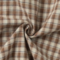 Macro shot of brown plaid fabric detail with ruffled pleats and fine textured weave - S / Brown