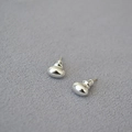 Macro shot of silver polished oval bean earrings on textured grey background - Silver Small