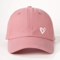 Close-up of pink cotton baseball cap with white heart embroidery and twill texture - One Size / Deep Pink