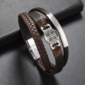 Makroaufnahme des mehrlagigen Lederarmbands mit rundem Metallanhänger und Magnetverschluss - Braun