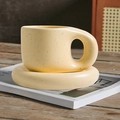 Yellow spotted ceramic chubby mug with matching saucer on a wooden table setup - 400ml / Yellow Splash Ink