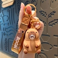 Brown capybara keychain with silicone charm and BOOM! braided wristlet strap - Brown Bubble Capybara