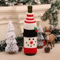 Cozy knitted snowman wine bottle cover displayed on a festive Christmas fireplace mantel - Snowman