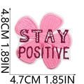 Macro detail of pink flower embroidery patch with Stay Positive text and 4.8cm size - STAY POSITIVE Pink Flower Style