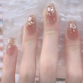 Close-up of pink gradient press-on nails with gold glitter and geometric rhinestones - Z590 Champagne Night / Nail Glue Version