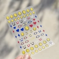 Detailed view of thin embossed smiley face nail stickers with matte finish and gold logo - Cute Matte Emoji Pack (to1537)