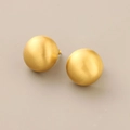 Macro detail of matte gold spherical stud earrings showing brushed metal texture - Brushed Sphere Studs / Gold