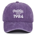 Close-up of white 1984 Vintage embroidery on a purple washed cotton baseball cap - Adjustable / Purple