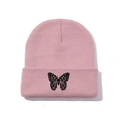 Close-up of pink knit beanie featuring detailed black butterfly embroidery on the cuff - One Size / Lotus root pink