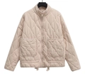 Close-up of wave quilted fabric with high stand collar and metal zipper detail - XS / Apricot