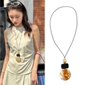 Ethnic style long necklace with amber resin geometric pendants on black cord - 52# Amber Spliced Round