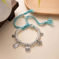 Detail of adjustable blue braided bracelet featuring traditional silver lucky charms - L393 Yellow Wealth God (Blue Rope)