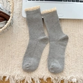 Gray knitted crew socks with cream lace trim and vertical ribbed texture on a cozy rug - One Size / Light Gray