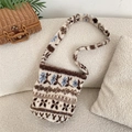 Close-up of winter fleece bucket bag with vintage snowflake patterns on white sofa - Wheat Ear