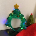 Green Christmas tree headband with LED lights, golden stars, and festive feathers - Light-up Green Tree Headband