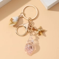 Llavero de metal con estrella de mar y concha luminosa y anillo dorado - Rosa Luminoso