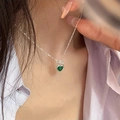 Silver necklace with a green heart pendant shown on a model neck for fashion styling - Green Heart Style (XL2784)
