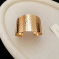 Detail of the golden cuff bracelet featuring handmade hammered metal texture finish - Gold Hammered Surface