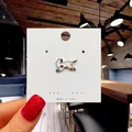 Cute white cat enamel pin with red floral accents on a card for bags and clothes - 124*Cat with Flower in Mouth Pin