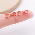 Rose gold pendant bail connector for jewelry DIY shown on a fingertip for scale - 6x15mm / Rose Gold