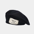 Close-up of black knitted beret showing thick texture and Season 13 woven label - Black