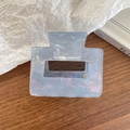 Iridescent light blue marble square hair claw clip for women on a rustic wood background - Blue