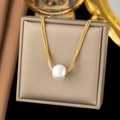Elegant gold snake chain necklace featuring a large white pearl pendant on a beige box - Large Bead / Gold