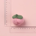Pink handmade crochet strawberry keychain charm with green leaf detail and scale measurement - Pink Peach Doll