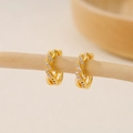 Detail of gold-plated twisted huggie earrings with sparkling cubic zirconia on wood bar - EH411023